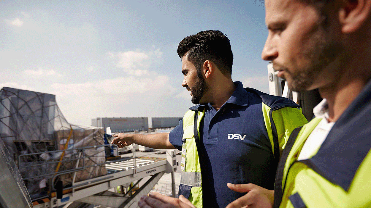 Two colleagues inspecting air freight on airport
