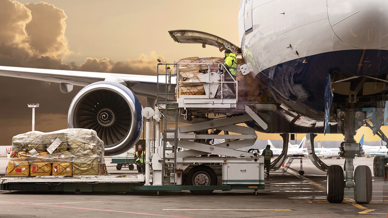 Freight standing next to an airplane ready to be loaded